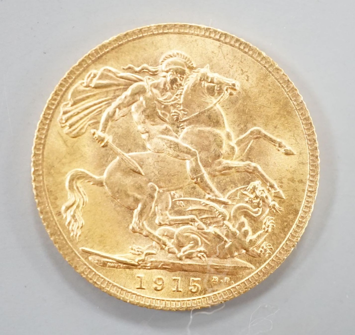 A George V 1915 gold sovereign.